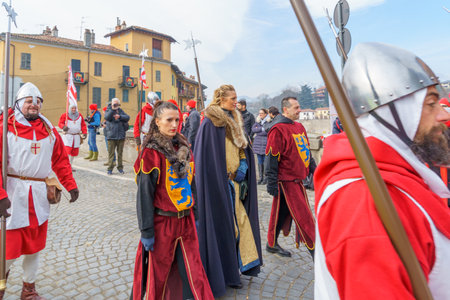 Ivrea, Italy - February 19, 2023: Participants in various costumes march, a tradition that is part of the historical carnival of Ivrea, Piedmont, Northern Italyのeditorial素材