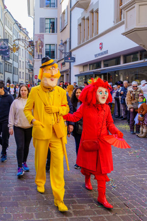 Lucerne, Switzerland - February 21, 2023: Scene of streets with participant and others, some in costumes, during the Fasnacht Carnival, in Lucerne (Luzern), Switzerlandのeditorial素材