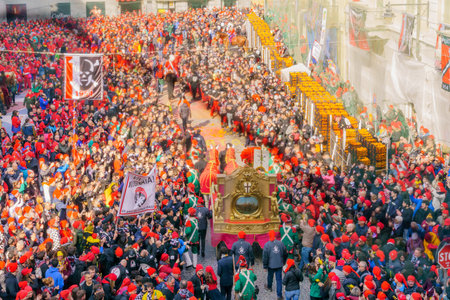 Ivrea, Italy - February 19, 2023: Scene of the town square (Piazza di Citta), with millers daughter cartridge and crowd, part of the historical carnival of Ivrea, Piedmont, Northern Italyのeditorial素材