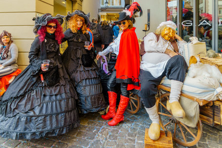 Lucerne, Switzerland - February 20, 2023: Scene of streets with participant and others, some in costumes, during the Fasnacht Carnival, in Lucerne (Luzern), Switzerlandのeditorial素材