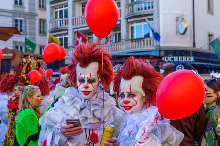 Lucerne, Switzerland - February 20, 2023: Scene of streets with participant and others, some in costumes, during the Fasnacht Carnival, in Lucerne (Luzern), Switzerlandのeditorial素材