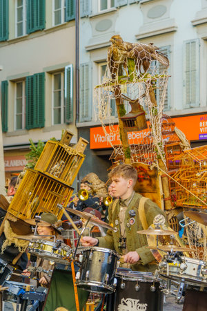 Lucerne, Switzerland - February 20, 2023: Band of musicians in costumes play to the crowd, part of the Fasnacht Carnival, in Lucerne (Luzern), Switzerlandのeditorial素材