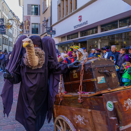 Lucerne, Switzerland - February 21, 2023: Scene of streets with participant and others, some in costumes, during the Fasnacht Carnival, in Lucerne (Luzern), Switzerlandのeditorial素材