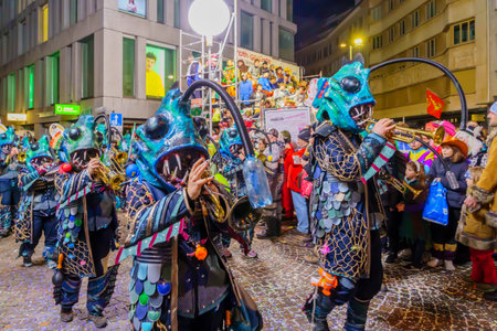 Lucerne, Switzerland - February 21, 2023: Band of musicians in costumes march in the streets, part of the final night parade of the Fasnacht Carnival, in Lucerne (Luzern), Switzerlandのeditorial素材