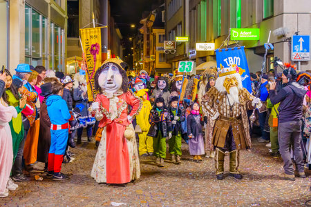 Lucerne, Switzerland - February 21, 2023: People in costumes take part of the final night parade of the Fasnacht Carnival, in Lucerne (Luzern), Switzerlandのeditorial素材