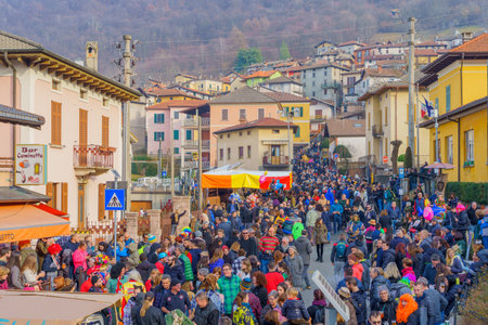 Schignano, Italy - February 18, 2023: Crowd of visitor and participants, part of the traditional carnival of Schignano, Lake Como, Lombardy, Northern Italyのeditorial素材