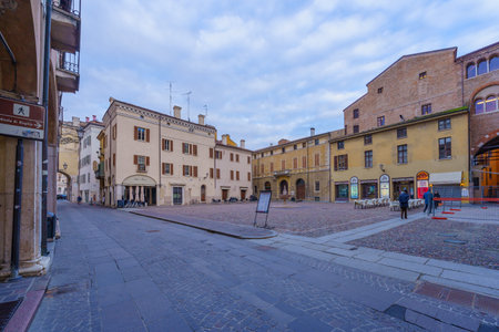 Mantua, Italy - February 27, 2023: View of the Piazza Broletto, with local monuments and businesses, locals, and visitors, in Mantua (Mantova), Lombardy, Northern Italyのeditorial素材