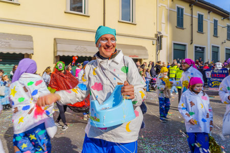Cantu, Italy - February 25, 2023: Carnival parade, dancers group, and crowd, in Cantu, Lombardy, Northern Italyのeditorial素材
