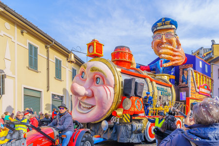 Cantu, Italy - February 25, 2023: Carnival parade, with allegorical figure wagon (Back to the past), in Cantu, Lombardy, Northern Italyのeditorial素材
