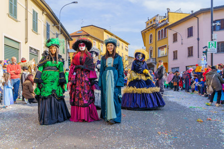 Cantu, Italy - February 25, 2023: Carnival parade, with displays and participants in costumes, in Cantu, Lombardy, Northern Italyのeditorial素材