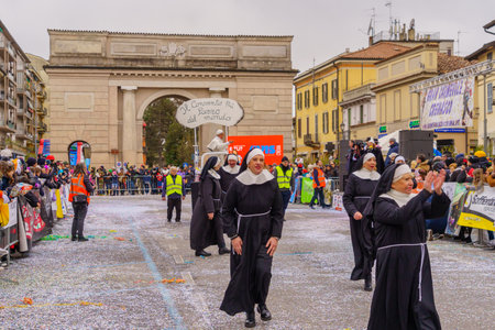 Crema, Italy - February 26, 2023: Carnival parade, with dancers in costumes, and crowd, in Crema, Lombardy, Northern Italyのeditorial素材