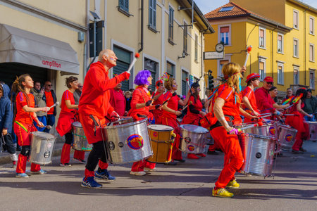 Cantu, Italy - February 25, 2023: Carnival parade, musician band, and crowd, in Cantu, Lombardy, Northern Italyのeditorial素材