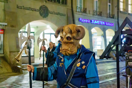 Bern, Switzerland - February 23, 2023: Group of people in costumes in the street, part of the carnival of Bern, Switzerlandのeditorial素材
