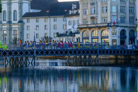 Lucerne, Switzerland - February 20, 2023: Band of musicians in costumes march on the Reussbrucke bridge, and crowd, part of the Fasnacht Carnival, in Lucerne (Luzern), Switzerlandのeditorial素材