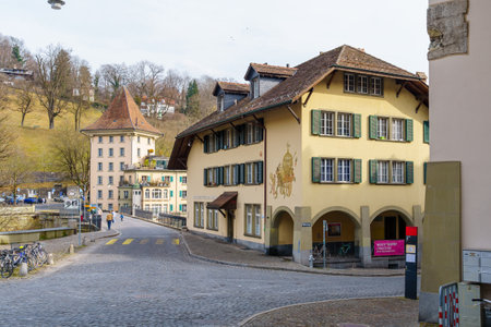 Bern, Switzerland - February 22, 2023: View of the Untertorbrucke bridge, with various buildings, locals, and visitors, in Bern, Switzerlandのeditorial素材