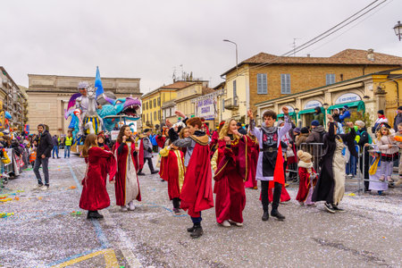 Crema, Italy - February 26, 2023: Carnival parade, with dancers in costumes, allegorical figure wagon, and crowd, in Crema, Lombardy, Northern Italyのeditorial素材