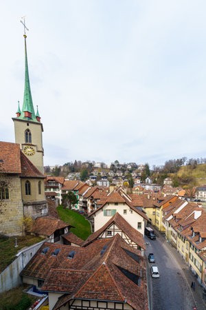Bern, Switzerland - February 22, 2023: View of the Mattenenge street, and the Nydeggkirche church, with various buildings, locals, and visitors, in Bern, Switzerlandのeditorial素材