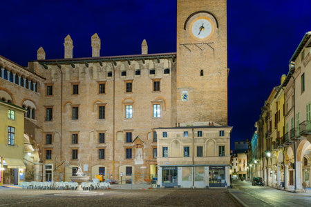 Mantua, Italy - February 27, 2023: Evening view of the Piazza Broletto, with local monuments and businesses, locals, and visitors, in Mantua (Mantova), Lombardy, Northern Italyのeditorial素材