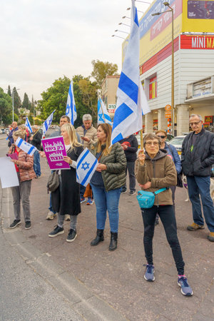 Haifa, Israel - March 23, 2023: Protesters with various signs and flags take part in a nationwide shutdown day, against the plans of the new government, claiming its anti-democratic, in Haifa, Israelのeditorial素材