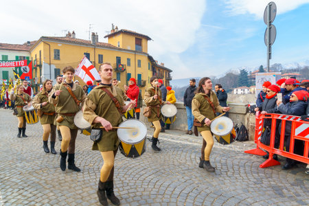 Ivrea, Italy - February 19, 2023: Band of musicians march, a tradition that is part of the historical carnival of Ivrea, Piedmont, Northern Italyのeditorial素材