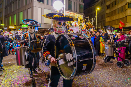 Lucerne, Switzerland - February 21, 2023: Band of musicians in costumes march in the streets, part of the final night parade of the Fasnacht Carnival, in Lucerne (Luzern), Switzerlandのeditorial素材