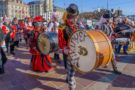 Lucerne, Switzerland - February 20, 2023: Band of musicians in costumes march in the streets, and crowd, part of the Fasnacht Carnival, in Lucerne (Luzern), Switzerlandのeditorial素材