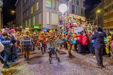 Lucerne, Switzerland - February 21, 2023: Band of musicians in costumes march in the streets, part of the final night parade of the Fasnacht Carnival, in Lucerne (Luzern), Switzerlandのeditorial素材