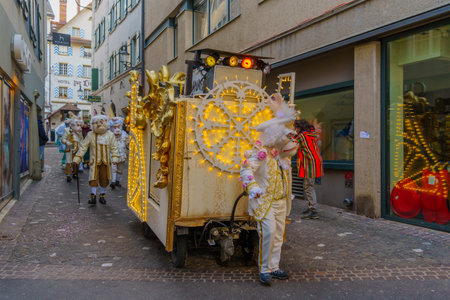 Lucerne, Switzerland - February 20, 2023: Group of participants in costumes march in the streets, and crowd, part of the Fasnacht Carnival, in Lucerne (Luzern), Switzerlandのeditorial素材