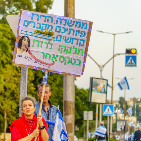 Haifa, Israel - April 22, 2023: Protesters with various signs and flags attend a demonstration against the plans of the new government, claiming its anti-democratic, in Haifa, Israelのeditorial素材