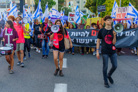 Haifa, Israel - April 22, 2023: Protest march with various banners, signs, and flags as demonstration against the plans of the government, claiming its anti-democratic, in Haifa, Israelのeditorial素材