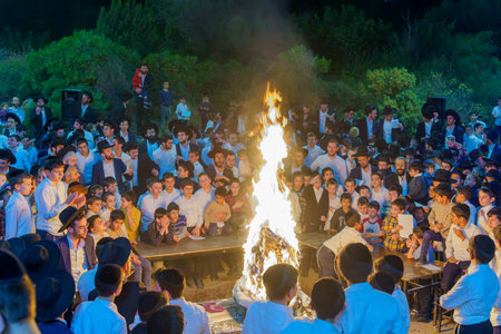 Haifa, Israel - May 08, 2023: Ultra-Orthodox Jews gather around a fire to celebrate the Annual Holiday of Lag-BaOmer, in Haifa, Israelのeditorial素材