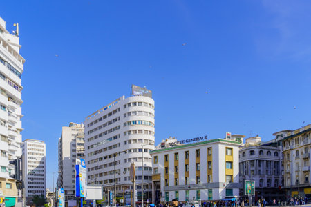 Casablanca, Morocco - March 29, 2023: Street view with various white buildings and pedestrians, in Casablanca, Moroccoのeditorial素材