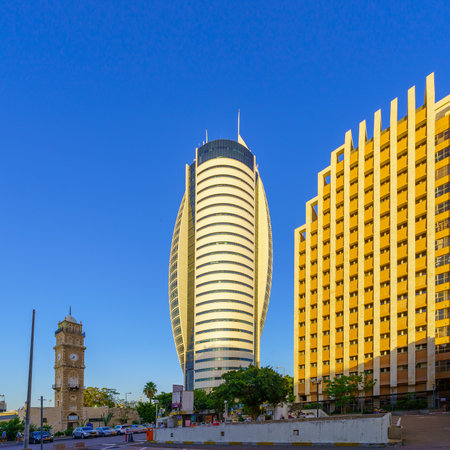 Haifa, Israel - May 04, 2023: View of the Minaret and clock tower of the Al Jarina Mosque (Jurayneh Ottoman Mosque, the Big Mosque), with modern office buildings, in Haifa, Israelのeditorial素材