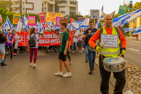 Haifa, Israel - May 13, 2023: People marching with flags and various signs. 19th week of anti-government protest in Haifa, Israelのeditorial素材