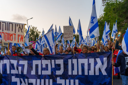 Haifa, Israel - May 13, 2023: People marching with flags and various signs. 19th week of anti-government protest in Haifa, Israelのeditorial素材