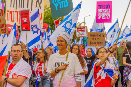 Haifa, Israel - May 13, 2023: People marching with flags and various signs. 19th week of anti-government protest in Haifa, Israelのeditorial素材