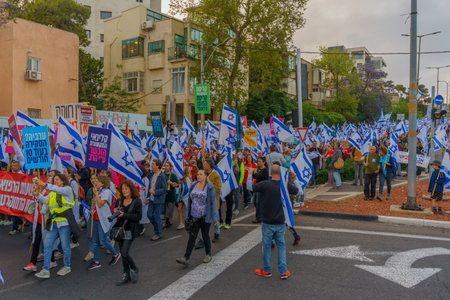 Haifa, Israel - May 13, 2023: People marching with flags and various signs. 19th week of anti-government protest in Haifa, Israelのeditorial素材