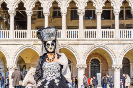 Venice, Italy - March 01, 2022: Woman dressed in traditional costume, in St. Marks Square, part of the Venice Mask Carnival, Veneto, Italyのeditorial素材