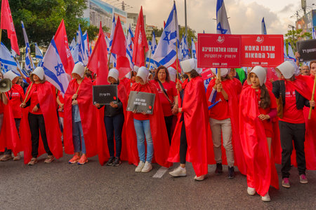 Haifa, Israel - May 20, 2023: People marching with flags and various signs (with women Handmaid Tale display). 20th week of anti-government protest in Haifa, Israelのeditorial素材