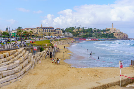 Tel-Aviv, Israel - May 21, 2023: Scene of the beach, the promenade, with locals, visitors, and old Jaffa. Tel-Aviv, Israelのeditorial素材