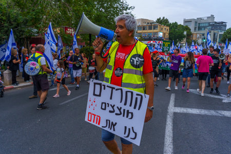 Haifa, Israel - May 27, 2023: People marching with flags and various signs. Week 21 of anti-government protest in Haifa, Israelのeditorial素材