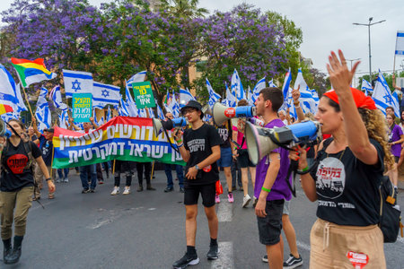 Haifa, Israel - May 27, 2023: People marching with flags and various signs. Week 21 of anti-government protest in Haifa, Israelのeditorial素材
