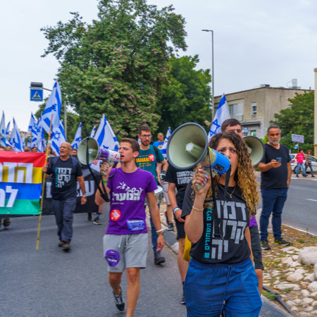 Haifa, Israel - May 27, 2023: People marching with flags and various signs. Week 21 of anti-government protest in Haifa, Israelのeditorial素材