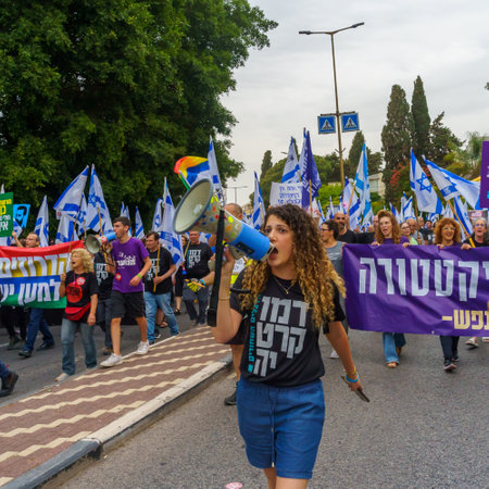 Haifa, Israel - May 27, 2023: People marching with flags and various signs. Week 21 of anti-government protest in Haifa, Israelのeditorial素材