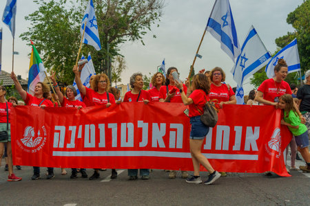 Haifa, Israel - May 27, 2023: People marching with flags and various signs. Week 21 of anti-government protest in Haifa, Israelのeditorial素材