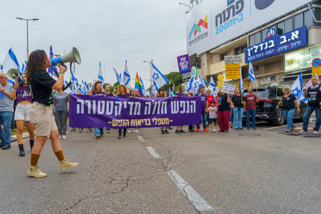 Haifa, Israel - May 27, 2023: People marching with flags and various signs. Week 21 of anti-government protest in Haifa, Israelのeditorial素材