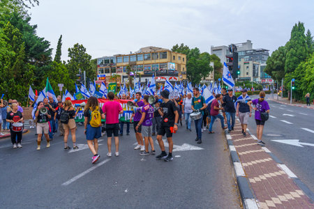 Haifa, Israel - May 27, 2023: People marching with flags and various signs. Week 21 of anti-government protest in Haifa, Israelのeditorial素材