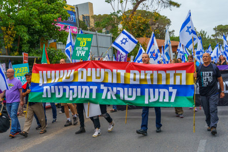 Haifa, Israel - May 27, 2023: People marching with flags and various signs. Week 21 of anti-government protest in Haifa, Israelのeditorial素材