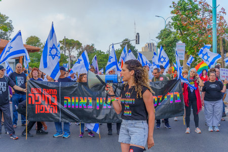 Haifa, Israel - June 10, 2023: People marching with flags and various signs. 23rd week of anti-government protest in Haifa, Israelのeditorial素材