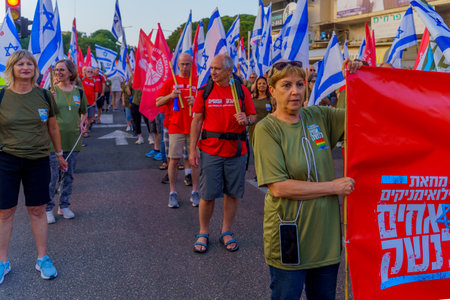 Haifa, Israel - June 10, 2023: People marching with flags and various signs. 23rd week of anti-government protest in Haifa, Israelのeditorial素材